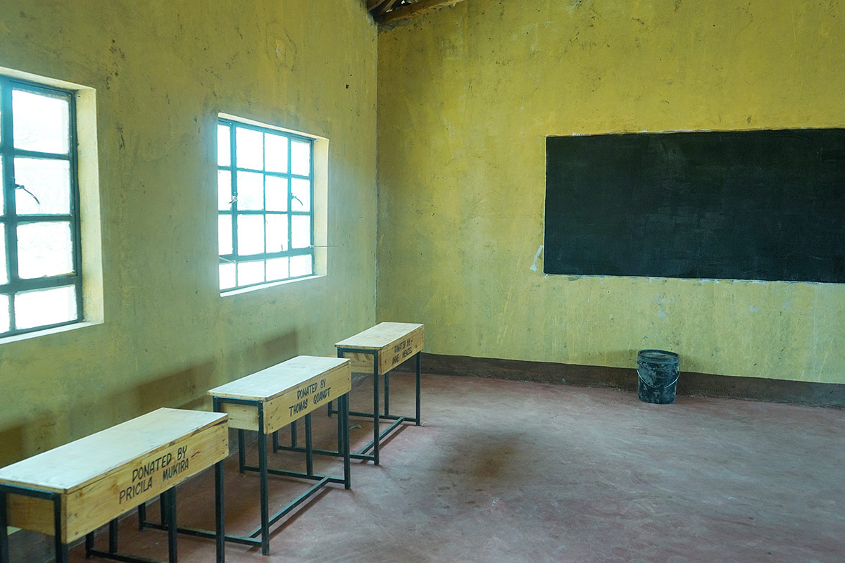 A classroom with the first school desks